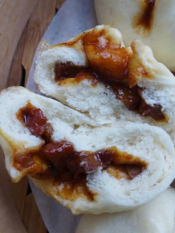 A Chinese BBQ pork bun torn in halves