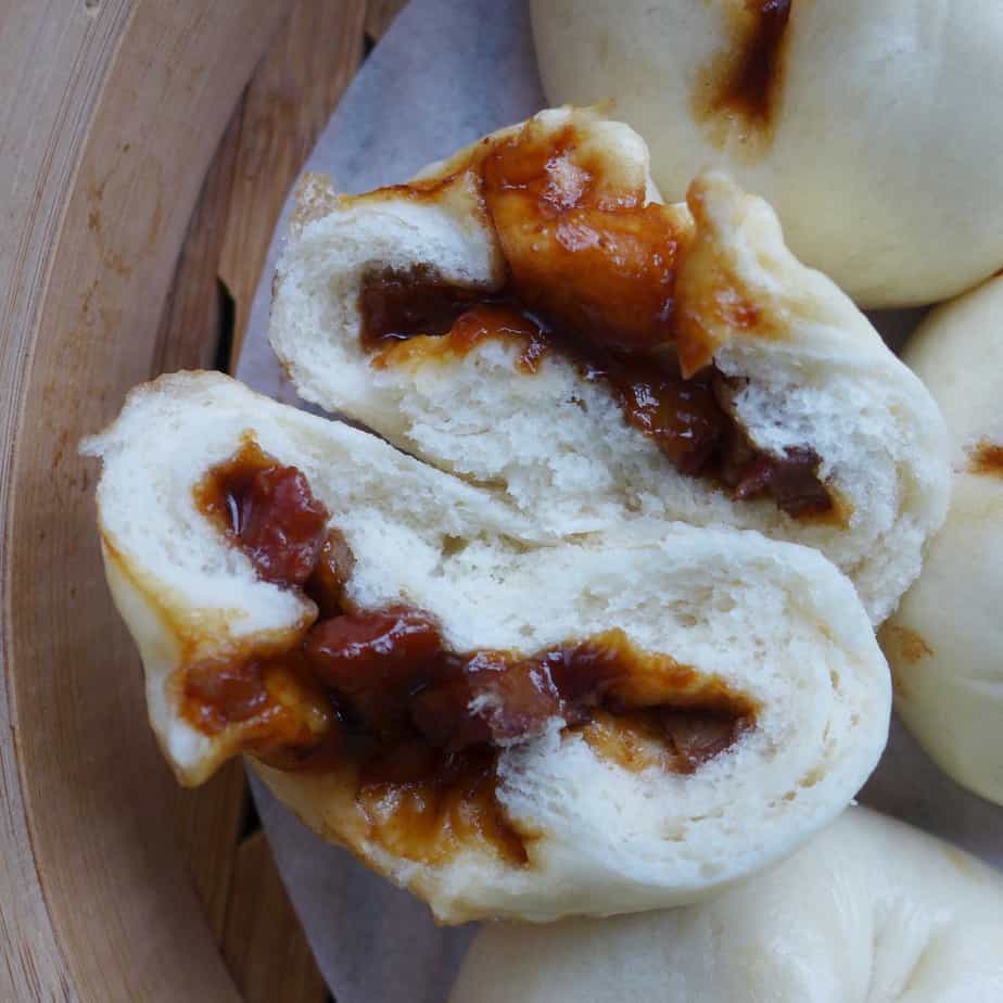 A Chinese BBQ pork bun torn in halves
