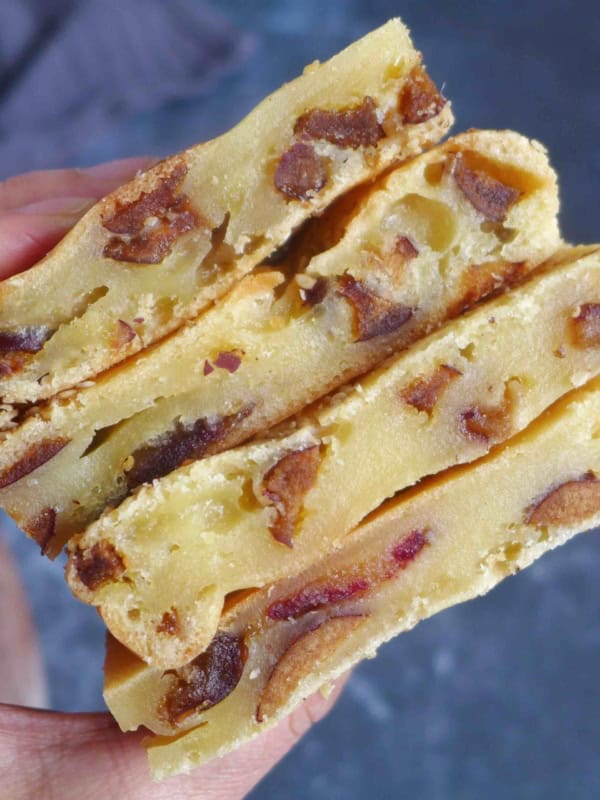 baked rice caked with dates held by hand.