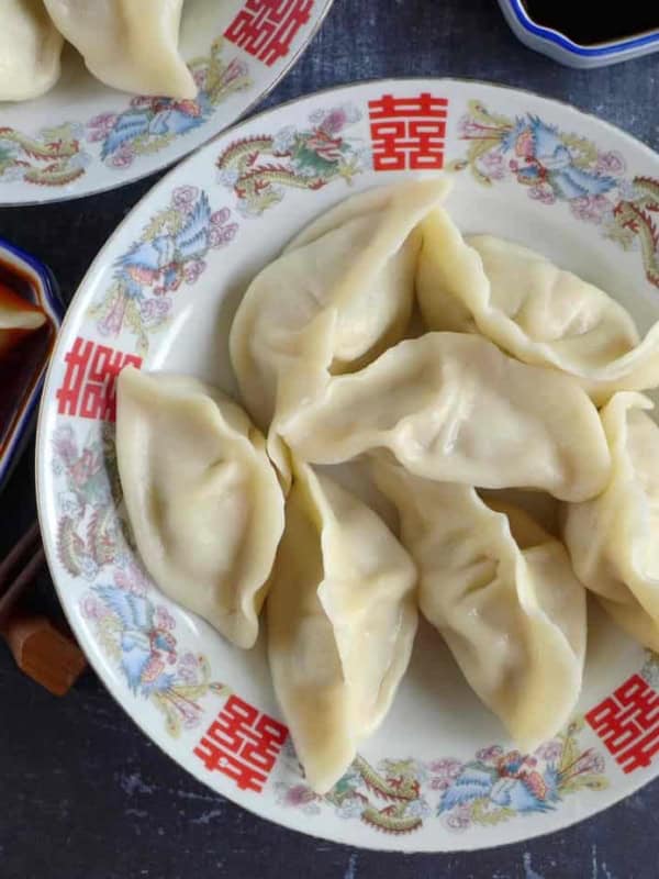 a plate of boiled pork dumplings