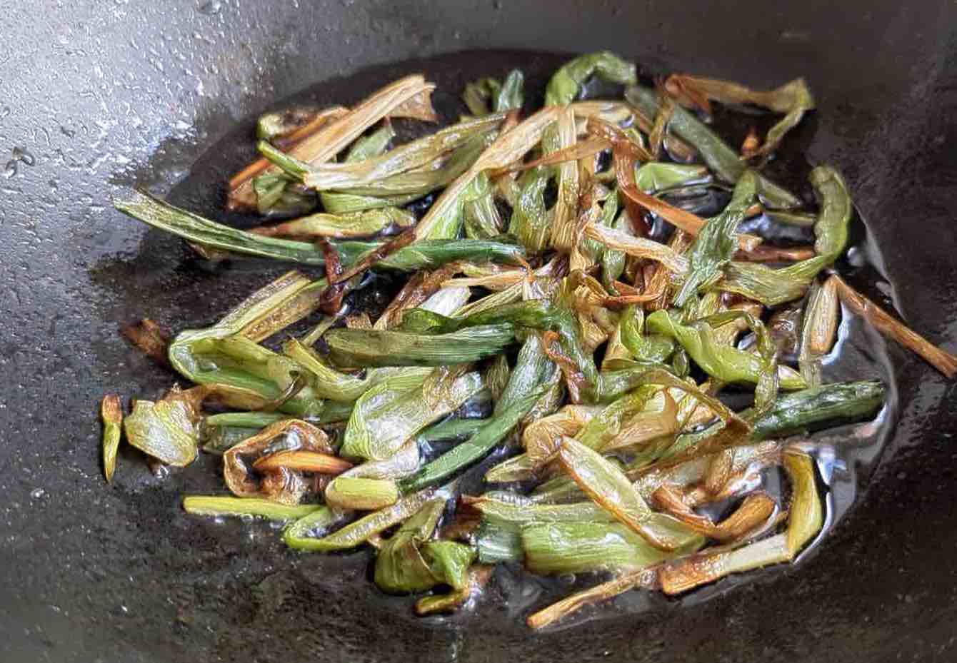 scallions getting brown in oil.