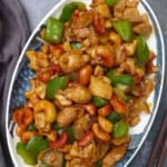 a stir-fry dish on a plate with overlay text that says cashew chicken.