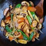 Frying chicken chop suey in a wok