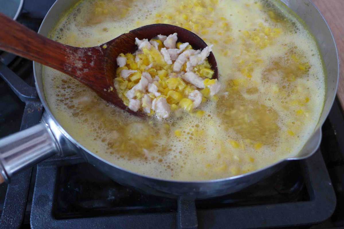 chicken pieces and corn kernels in soup.