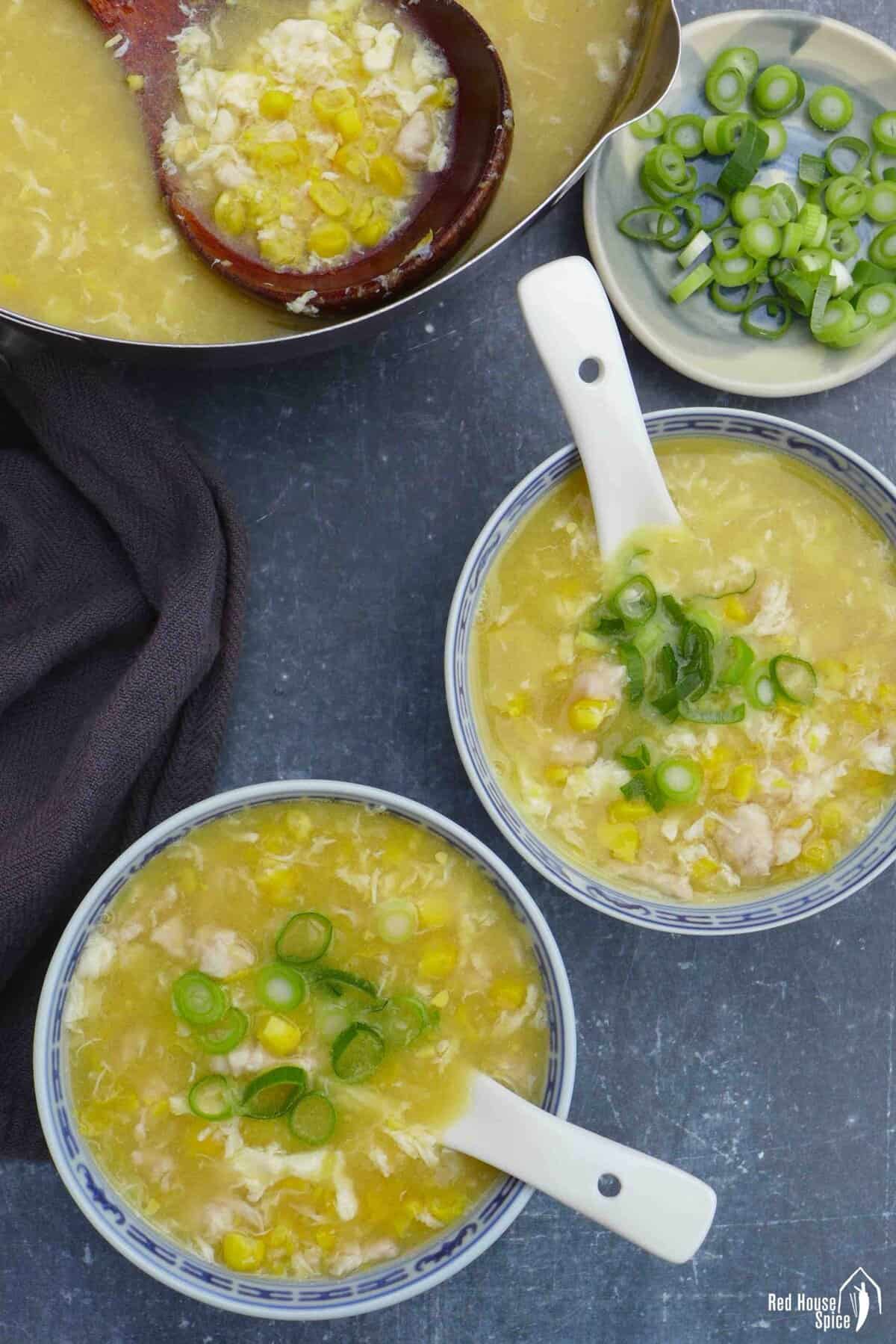 two bowls of chicken corn soup.