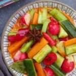 a plate of pickled vegetables with overlay text that says chinese overnight pickles.