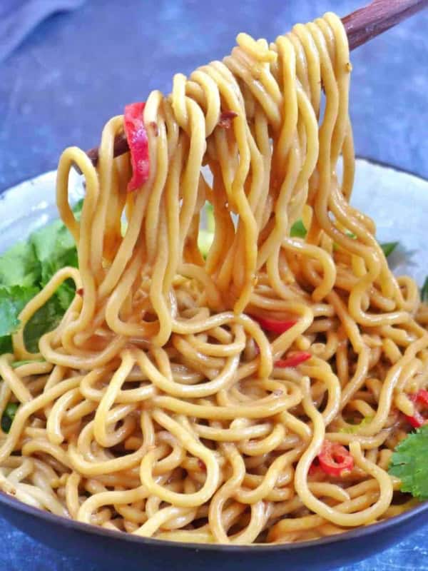 Pulling up Chinese sesame noodles with chopsticks.