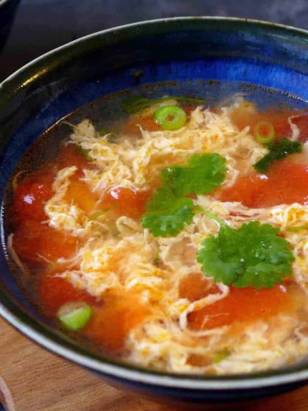 A bowl of tomato egg drop soup.