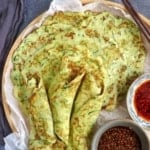 zucchini pancakes on a tray with sauces.