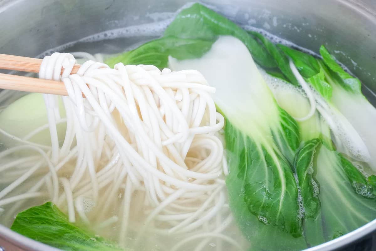 boiling noodles and bok chok.