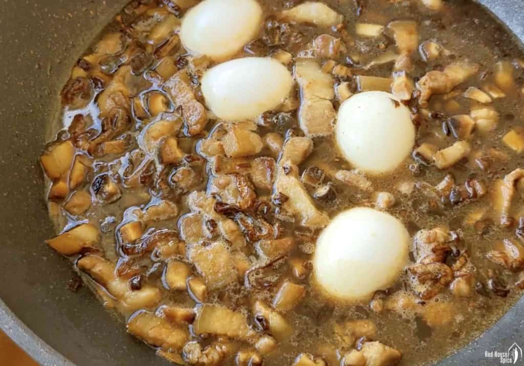 hard boiled eggs and braised pork in a wok