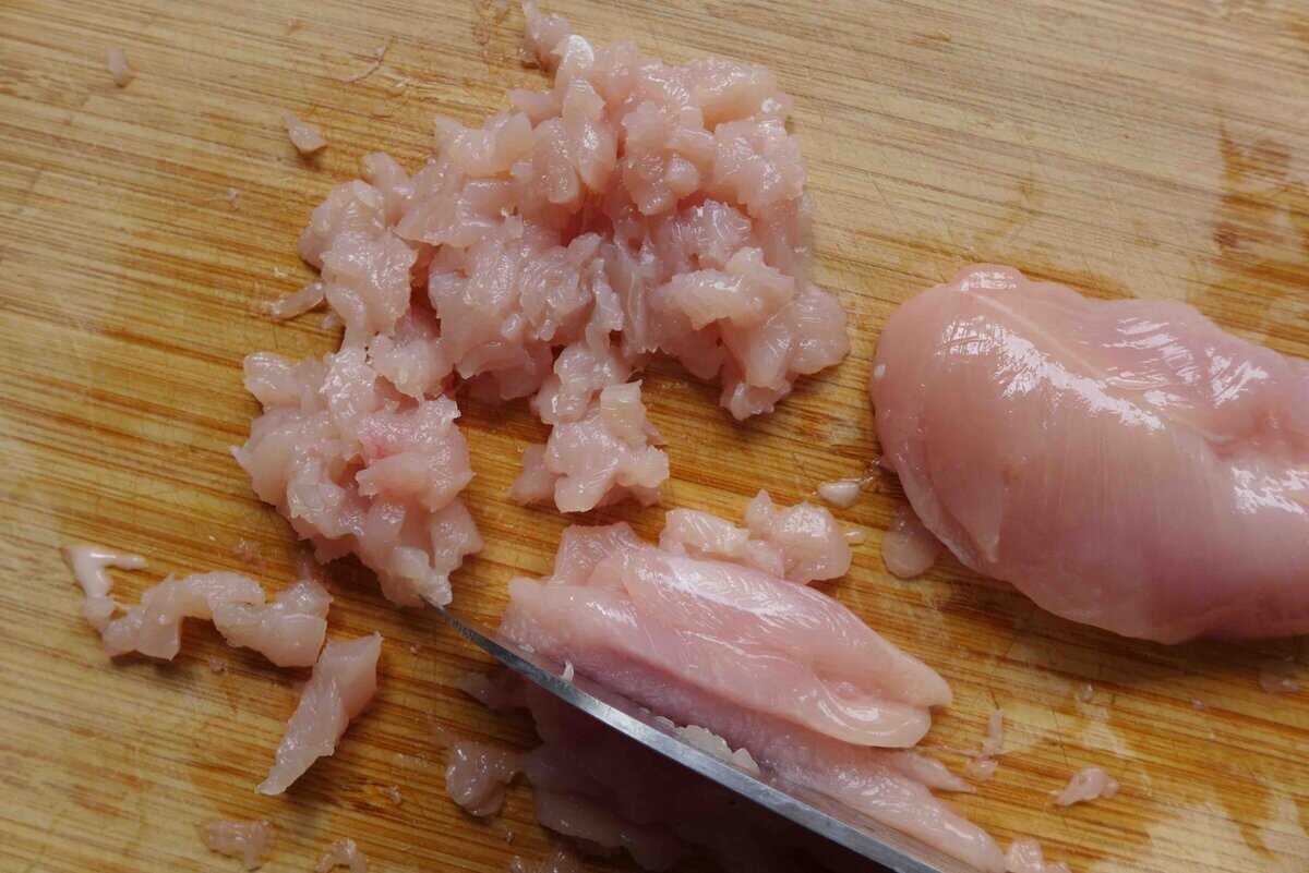 cutting chicken into small pieces.
