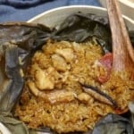 stick rice, chicken, sausage and mushrooms over a lotus leaf with overlay text that says stick rice chicken.
