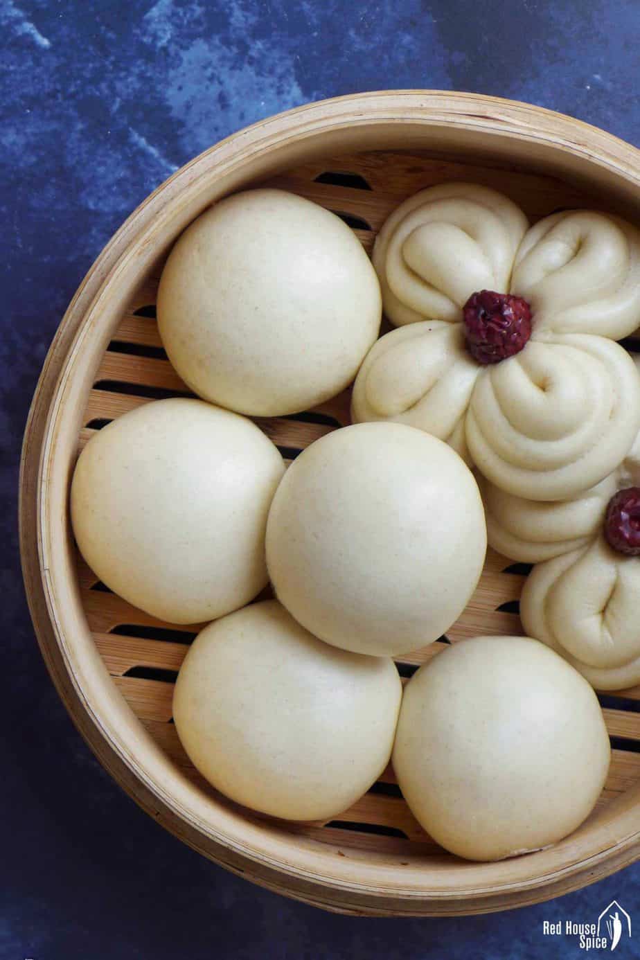 Chinese steamed buns in a bamboo basket.