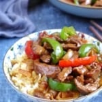 pepper steak over a bowl of rice.
