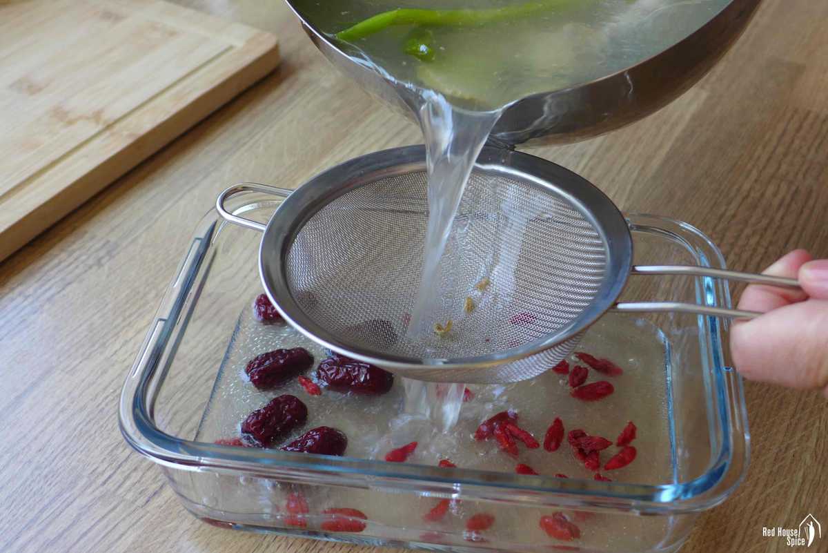 pouring chicken stock into a container