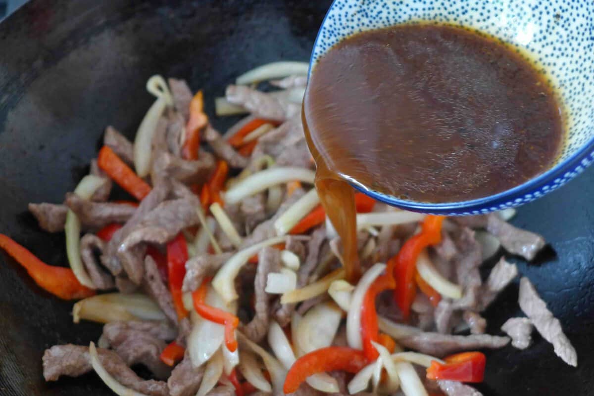 pouring sauce to wok.
