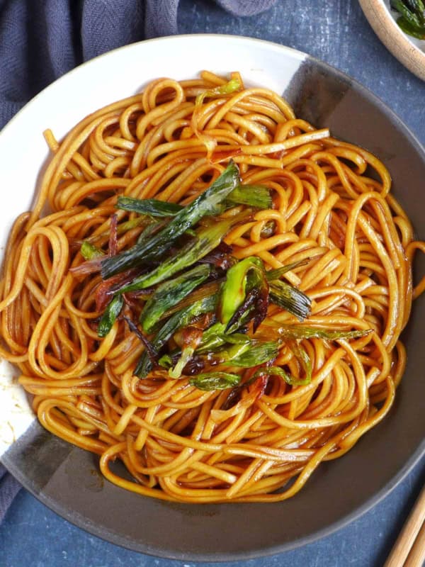 scallion oil noodles garnished with fried scallions.
