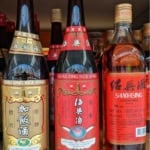 three bottles of Shaoxing rice wine with overlay text that says shaoxing wine guide.