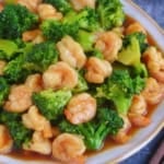stir-fried shrimp and broccoli on a plate.