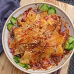slices of pork over cucumber in a spicy dressing.