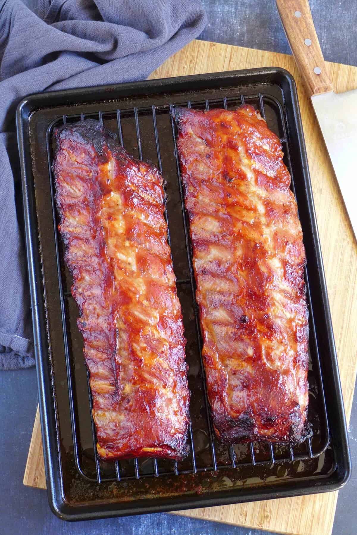 two racks of Chinese BBQ ribs on a baking tray.